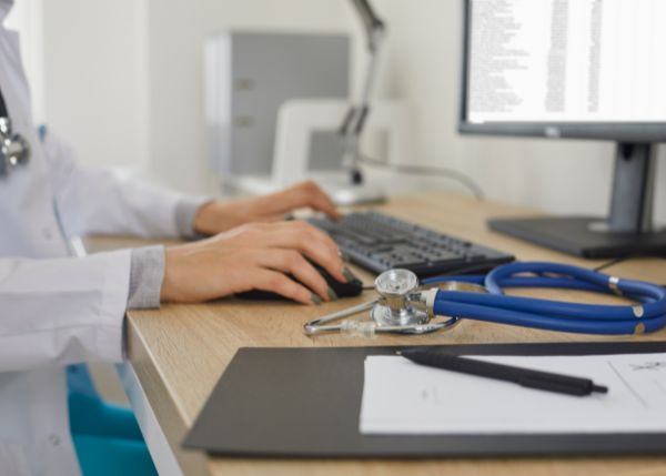 A doctor using a desktop computer