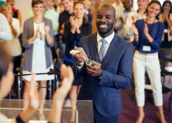 Man receiving award trophy