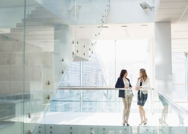 Two women standing in an office building