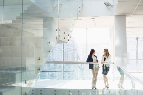 Two women standing in an office building