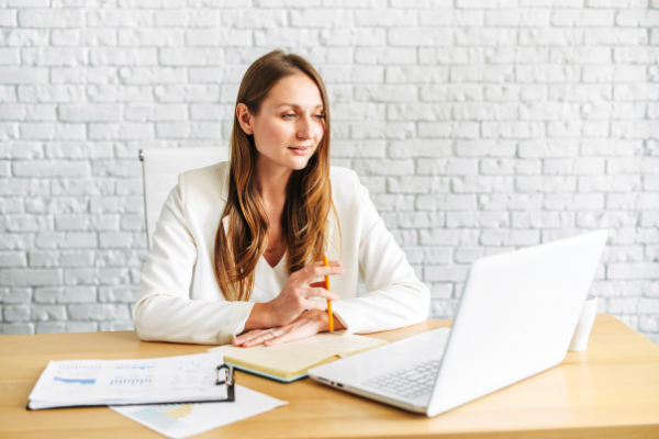 Young professional woman looking at laptop