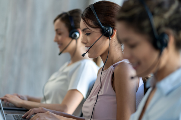 three women wearing headsets