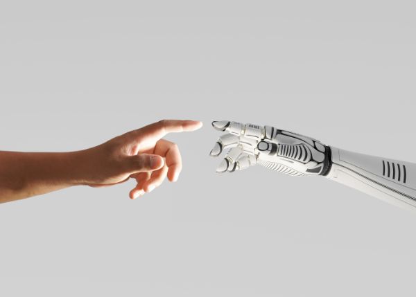 A human hand and an artificial hand reaching out to one another