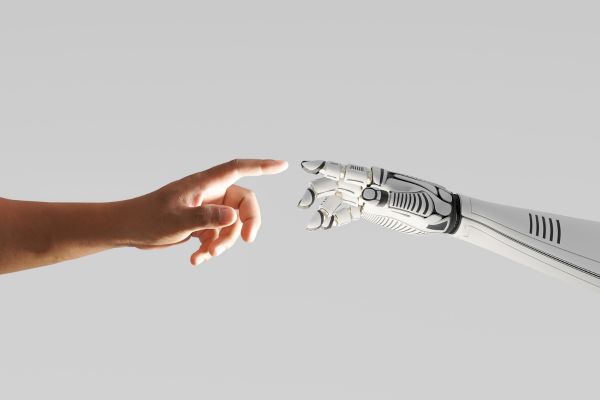 A human hand and an artificial hand reaching out to one another