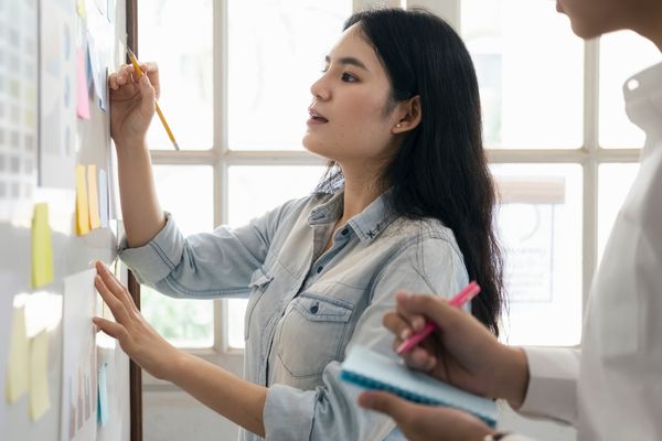 A woman writing on sticky notes