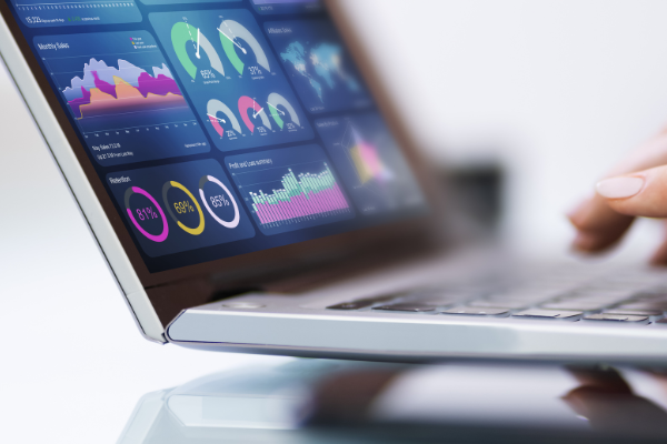 out of focus laptop with graphs and grids on the screen