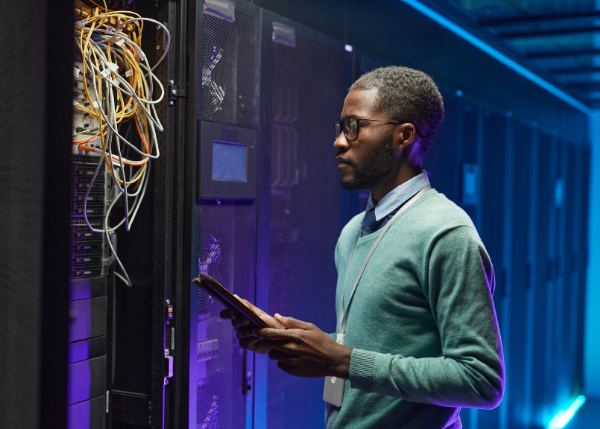 person standing in front of cabling in data center