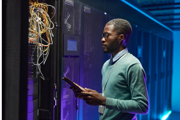 person standing in front of cabling in data center