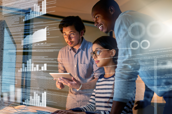 three people working together with virtual chart graphics overlaid
