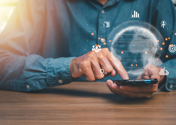 hands holding a phone with virtual finance-related icons