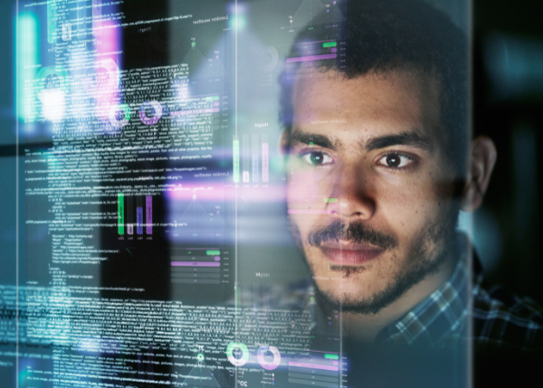 person looking at virtual graphics and code