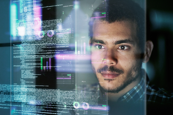 person looking at virtual graphics and code
