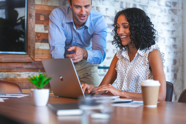woman working with man on a laptop