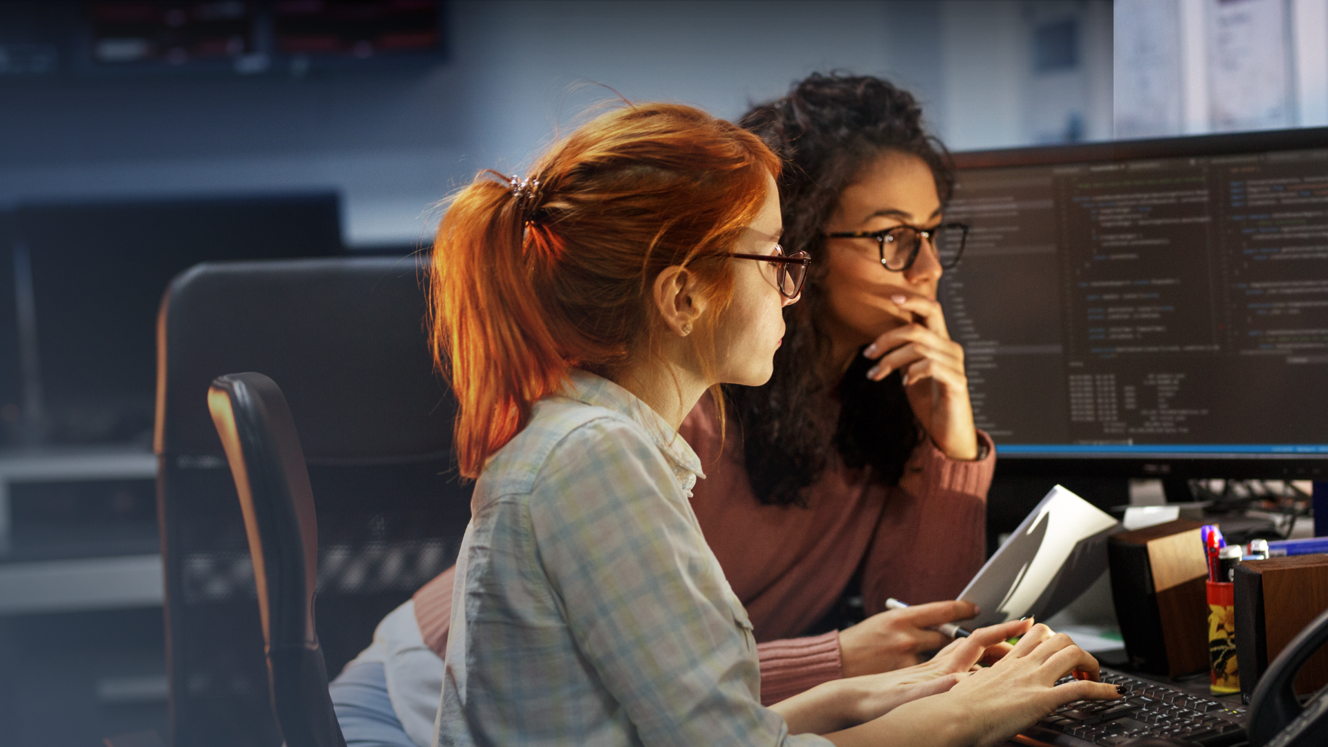 two women looking at computer