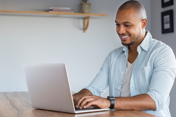 man typing on laptop computer