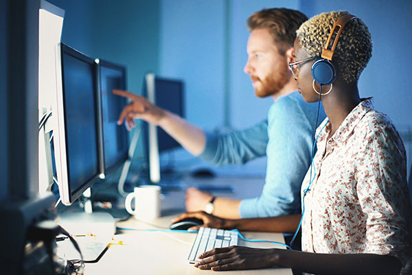 Two men looking at computer