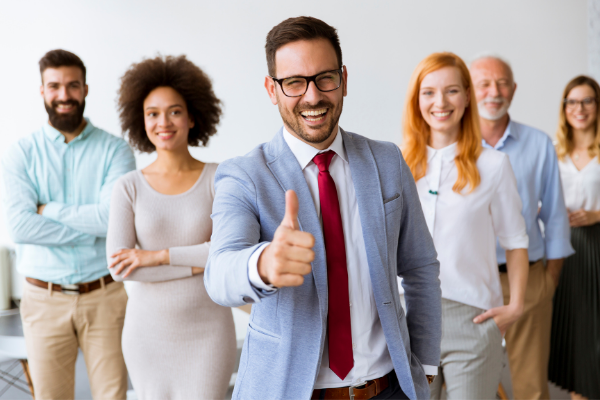 Diverse business professionals in v-formation, lead-front smiling, thumbs up