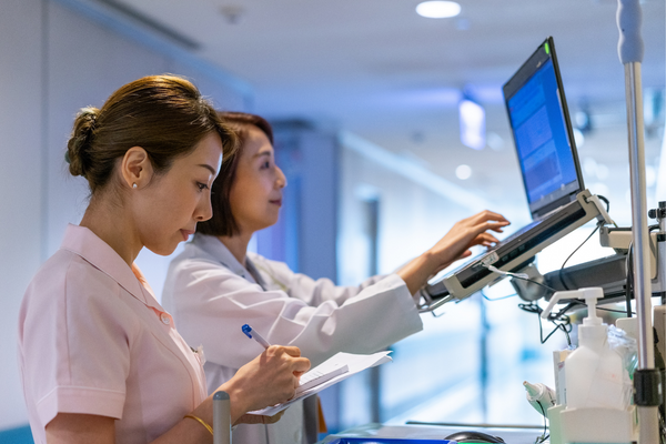 two healthcare workers using laptop
