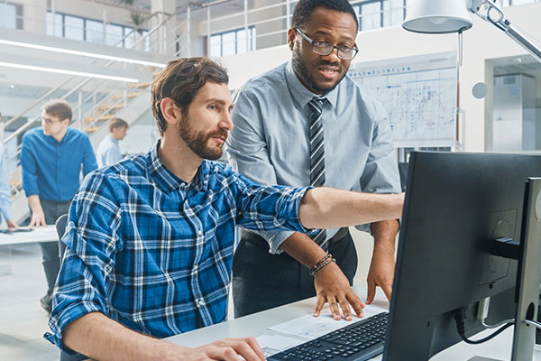 Two men looking at computer