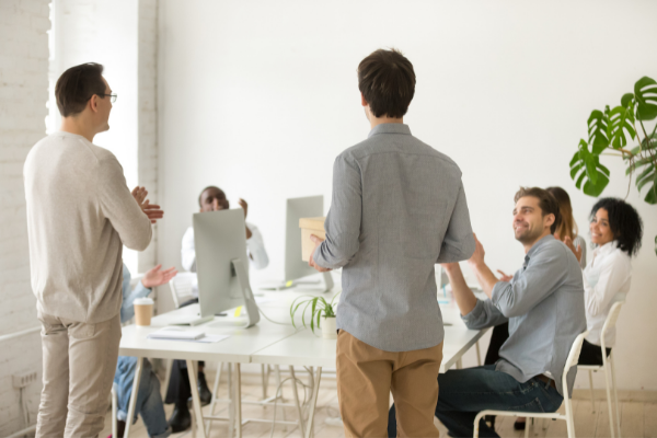 Team members applauding new hire