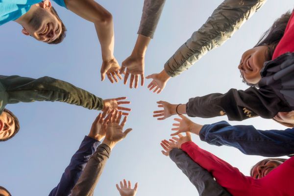 Group of people putting their hands together in a circle