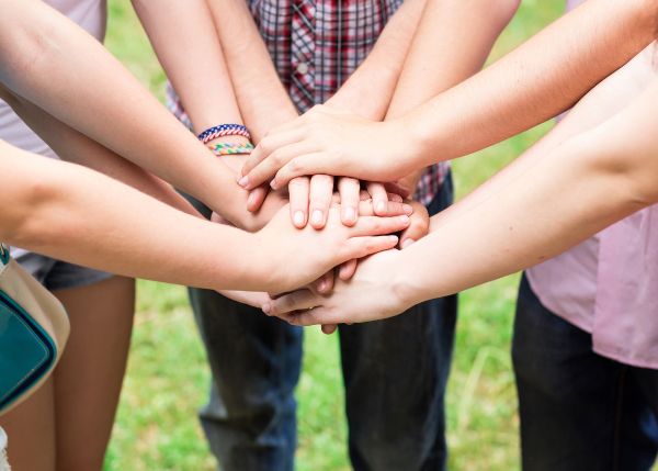 Group of teens with hands together