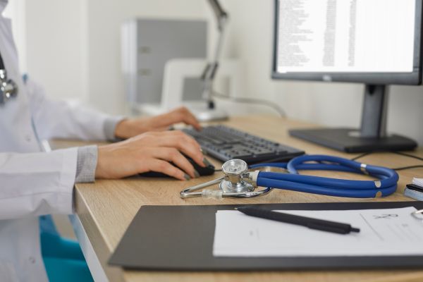 A doctor using a desktop computer