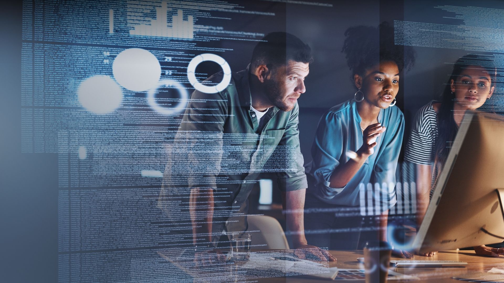 Three people looking at monitor, clear tech icons and graphs overlaid on image