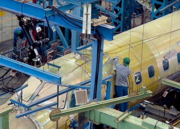 an engineer working on an unfinished airplane