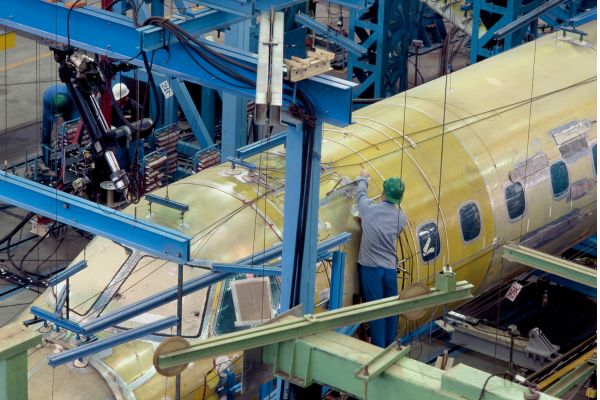 an engineer working on an unfinished airplane
