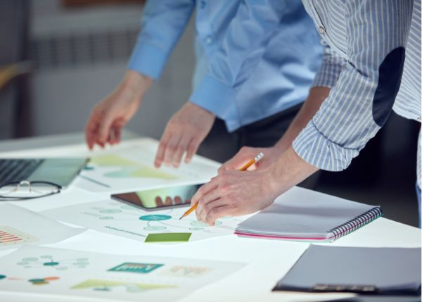 two men going through an array of documents