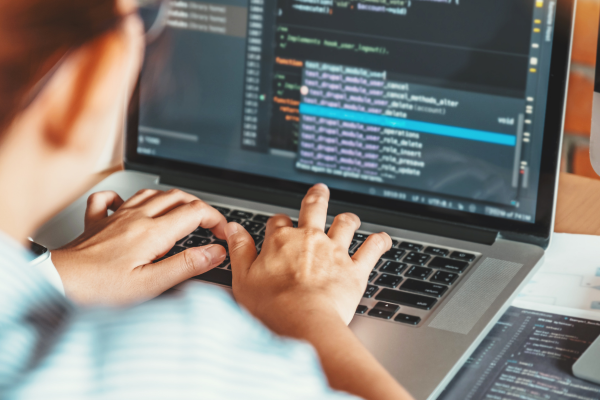 Person coding on a laptop