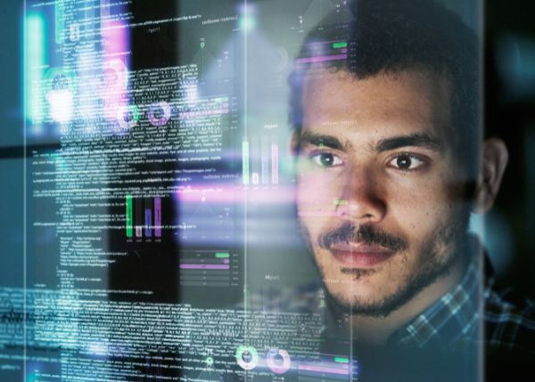 Man looking at computer programming 