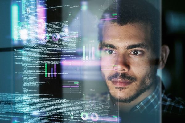 Man looking at computer programming 