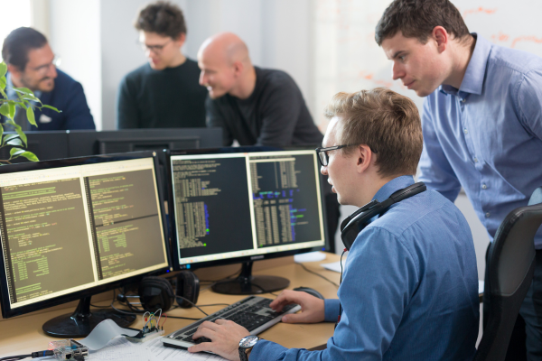 IT workers looking at monitors.