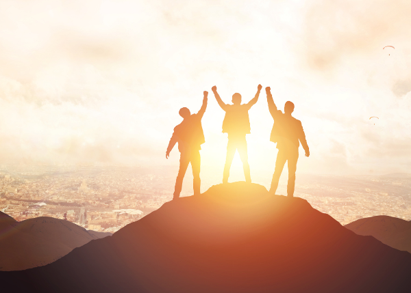 Men on a peak celebrating
