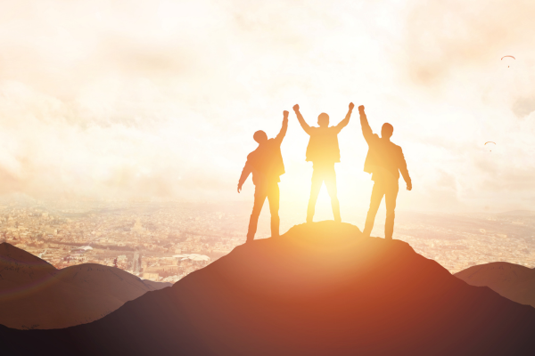 Men on a peak celebrating 