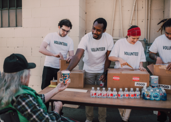 Volunteers giving out food and care items
