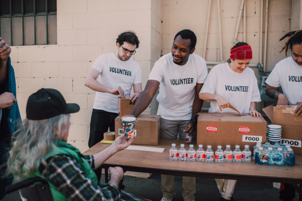 Volunteers giving out food and care items