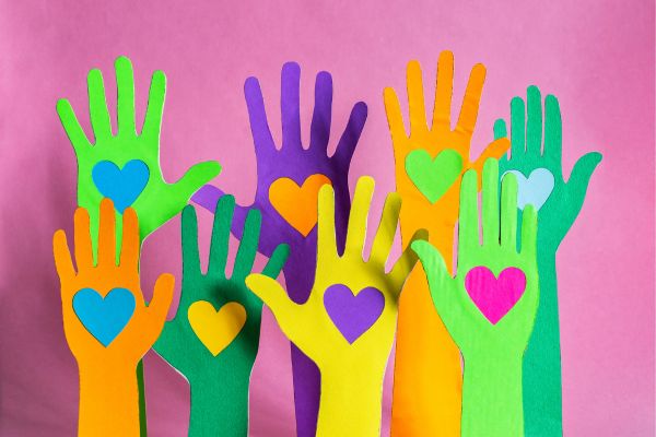 Colorful hands with hearts inside