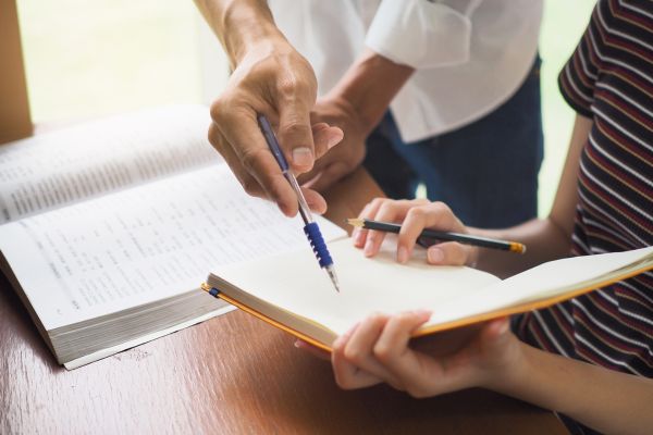 Adult helping a student with homework