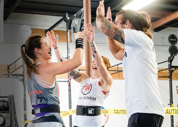 Group of people high-fiving after working out
