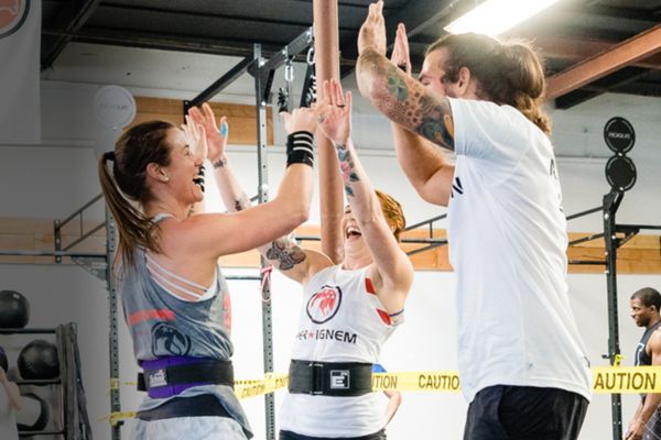 Group of people high-fiving after working out