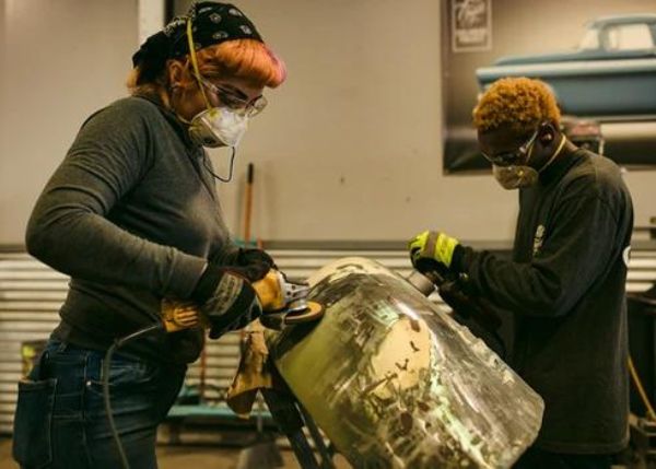 Two teens working in a shop
