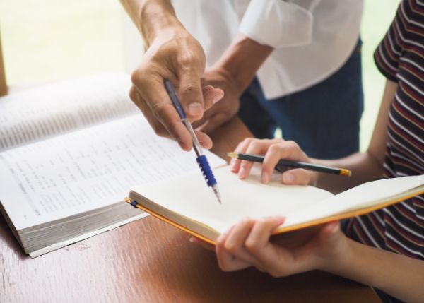 Adult helping a student with homework