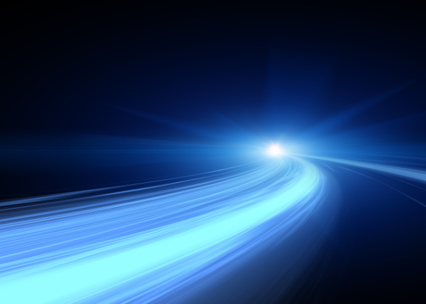 Abstract image of blue light trails curving toward a bright point on a dark background.