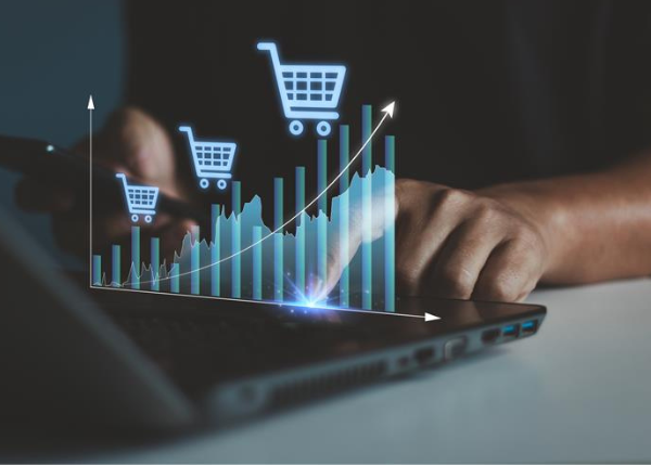 Person typing on laptop with graph of cart sales increasing