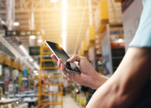 person using mobile device in warehouse