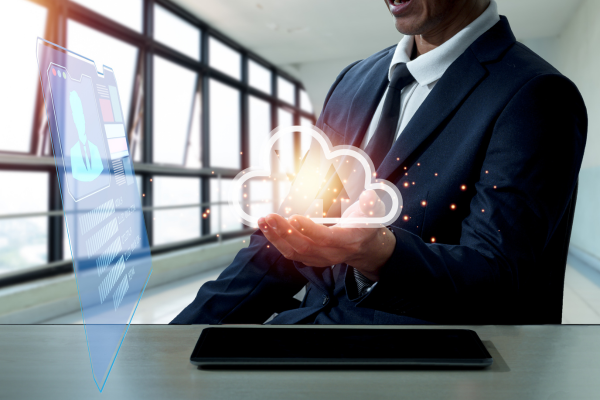 Businessman holding a cloud based technology
