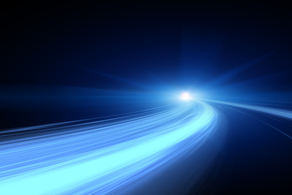 Abstract image of blue light trails curving toward a bright point on a dark background.